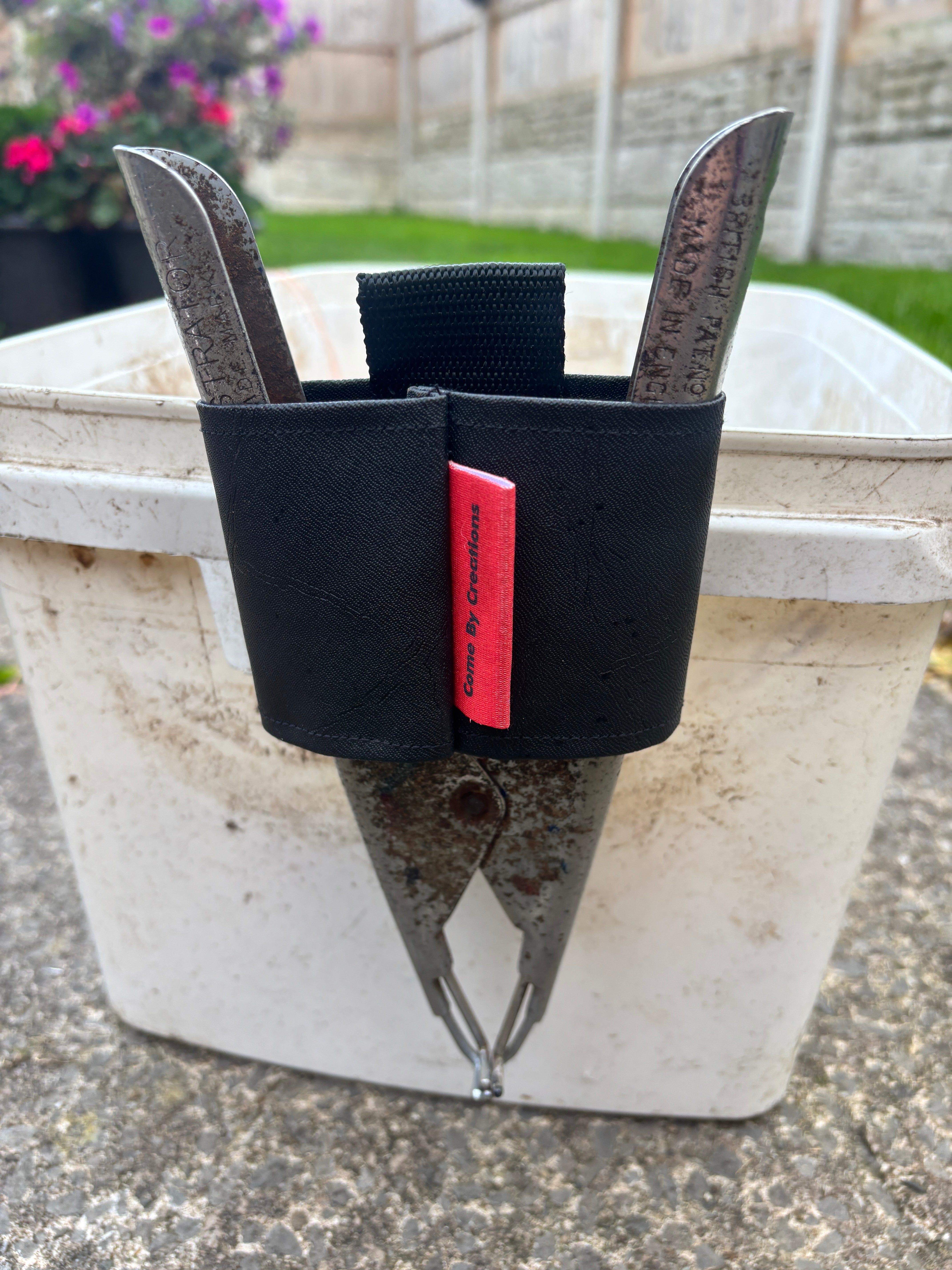 castration ring plier holder clip on side of bucket